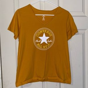 Medium mustard colored converse shirt.